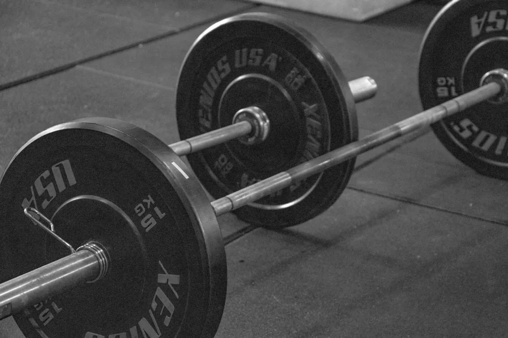a black and white photo of a barbell weight weights in a gym
