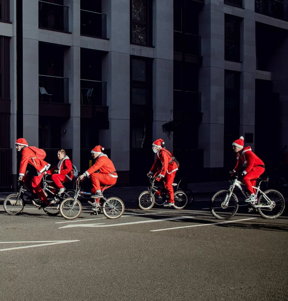 group of people wearing Santa costume riding bikes